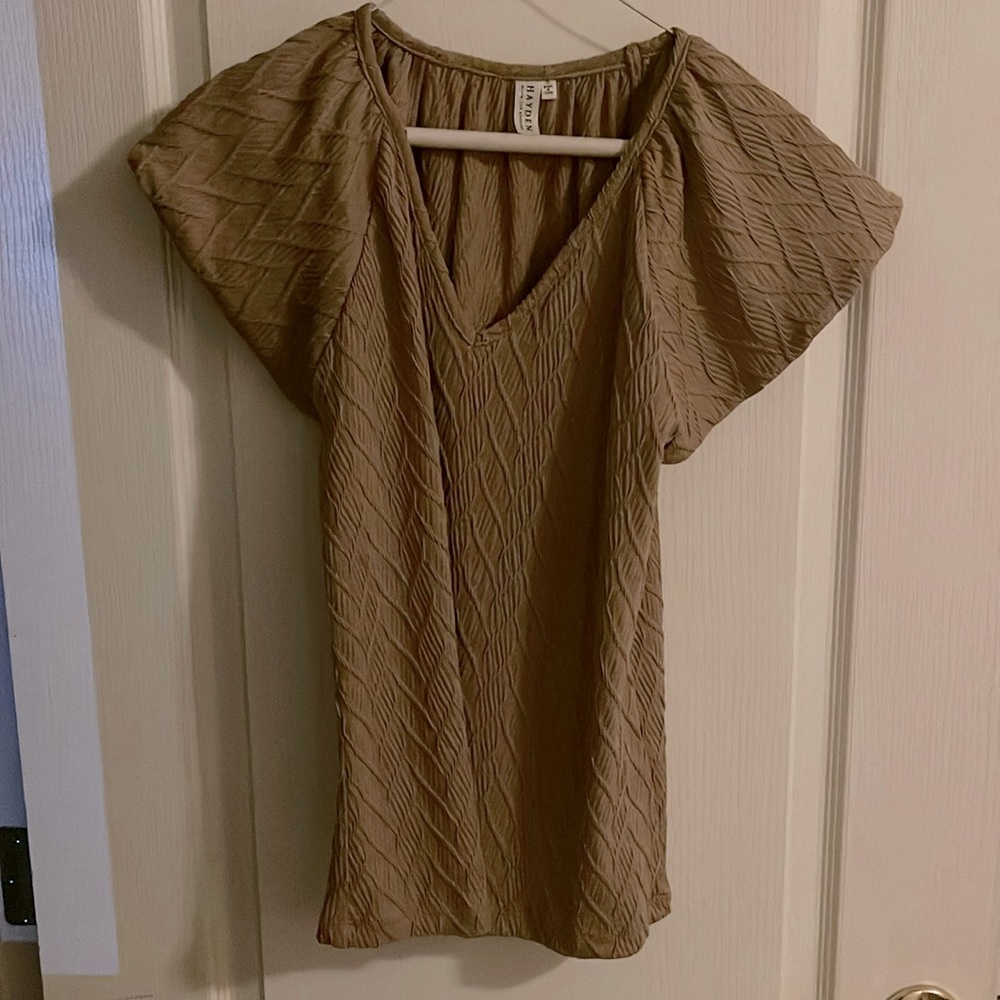 Lovely blouse by Hayden.  Size small. Beige in color.  Rests at the hip